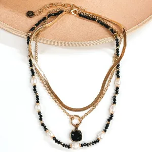 Pink Panache | Three Strand Pearl and Black Beaded Necklace with Gold Chains and Black Cushion Cut Crystal Drop